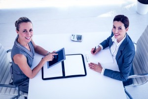 Businesswomen working together at desk in the office