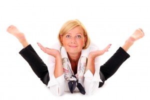 A picture of a mature flexible woman lying over white background