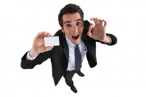 Excited man holding business card